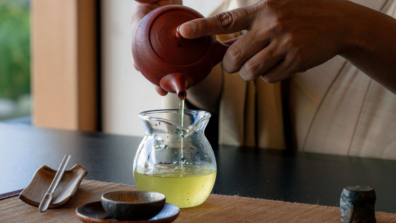 Japanese Green Tea (Shincha) poured from a traditional Japanese Kyusu (tea pot), into a Yuzamashi (cooling vessel) by a Tea Master