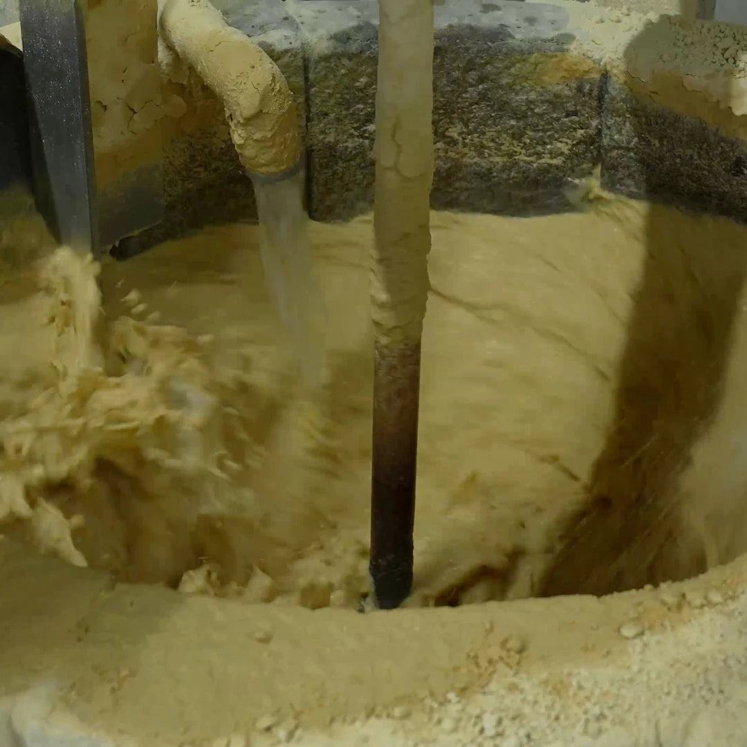 Close-up of clay mixed with water inside a basin, to filter impurities.