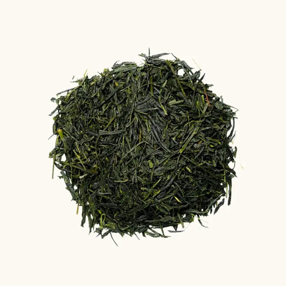 A pile of shaded-grown Japanese tea Gyokuro on a beige background