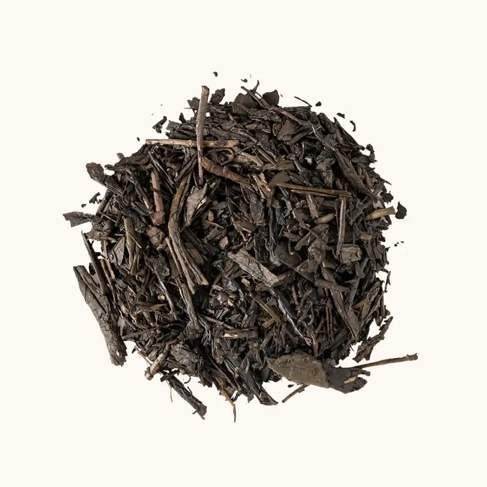 A pile of roasted Japanese green tea Hojicha on a beige background