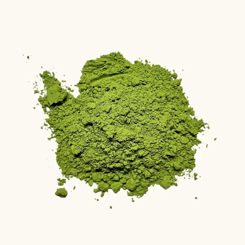 A pile of Japanese green tea powder Matcha on a beige background