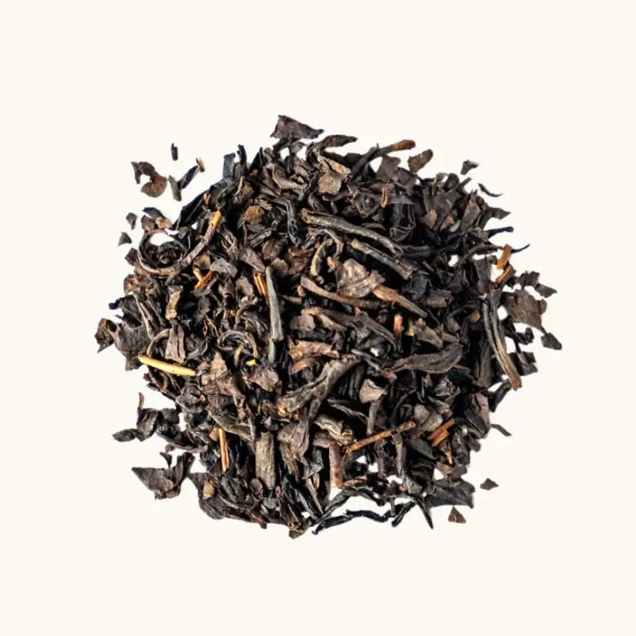 A pile of fermented Japanese black tea (Wakoucha) on a beige background