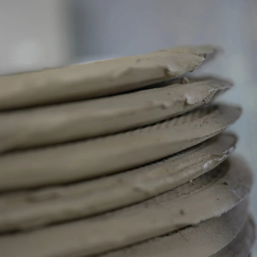 A pile of dehydrated clay compressed into a disk shape for better storage.