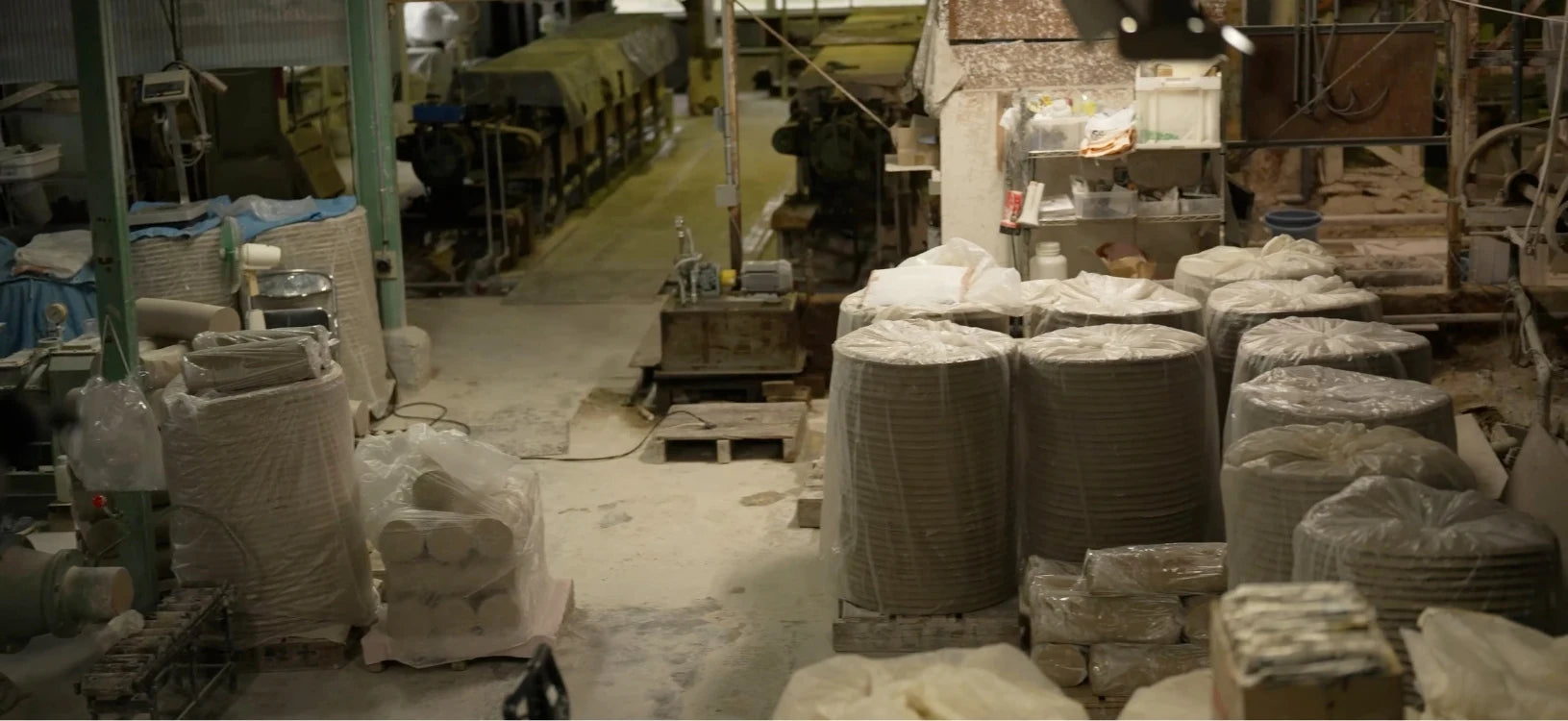 Factory floor with stacks of materials and machinery from Taniguchi Clay Factory