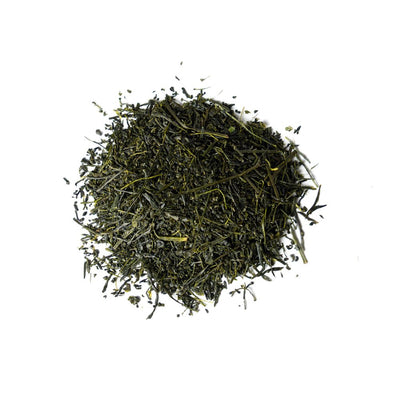 A pile of fresh Sencha leaves on a white background