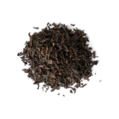 Pile of Japanese black tea leaves on a white background.