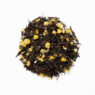 A pile of Japanese roasted green tea hojicha, chamomile and lemon verbena on a white background