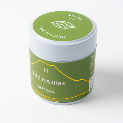 A green and white labeled Matcha tin can branded "Mohei", with the name Thé Hajime, on a white background.