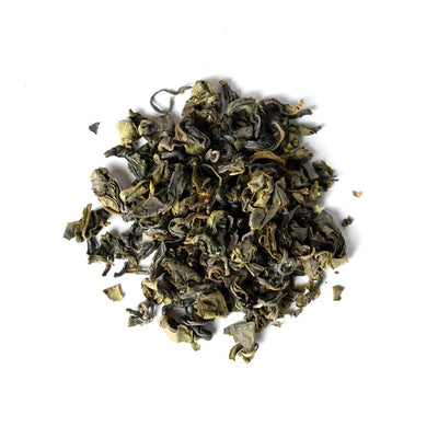A pile of Kamairicha green tea leaves on a white background